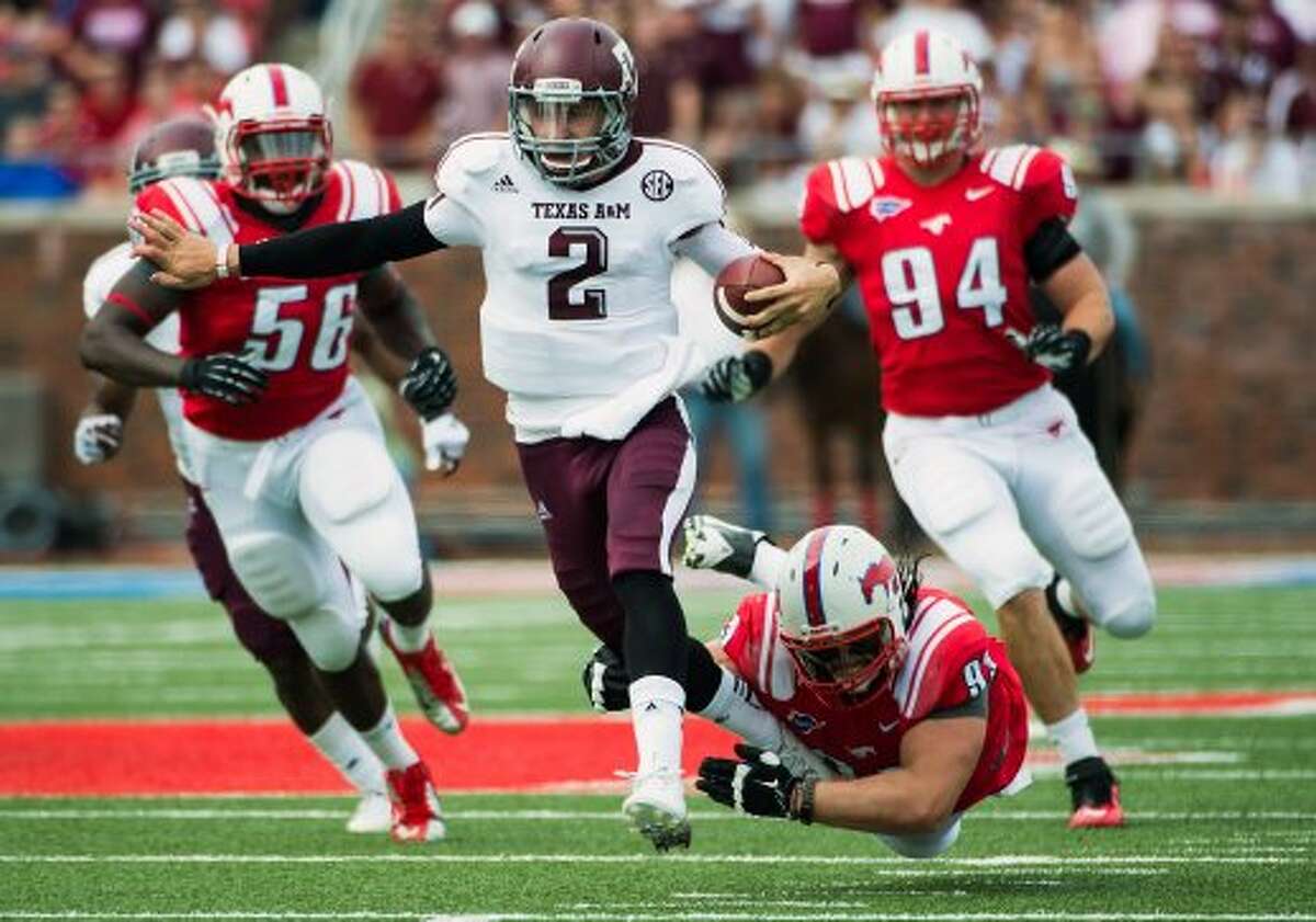 Texas A&M quarterback Johnny Manziel (2) breaks free from Southern Methodist defensive tackle Aaron Davis (93) on a 48-yard touchdown run during the second quarter of an NCAA football game at Ford Stadium, Saturday, Sept. 15, 2012, in Dallas. ( Smiley N. Pool / Houston Chronicle ) (Houston Chronicle)