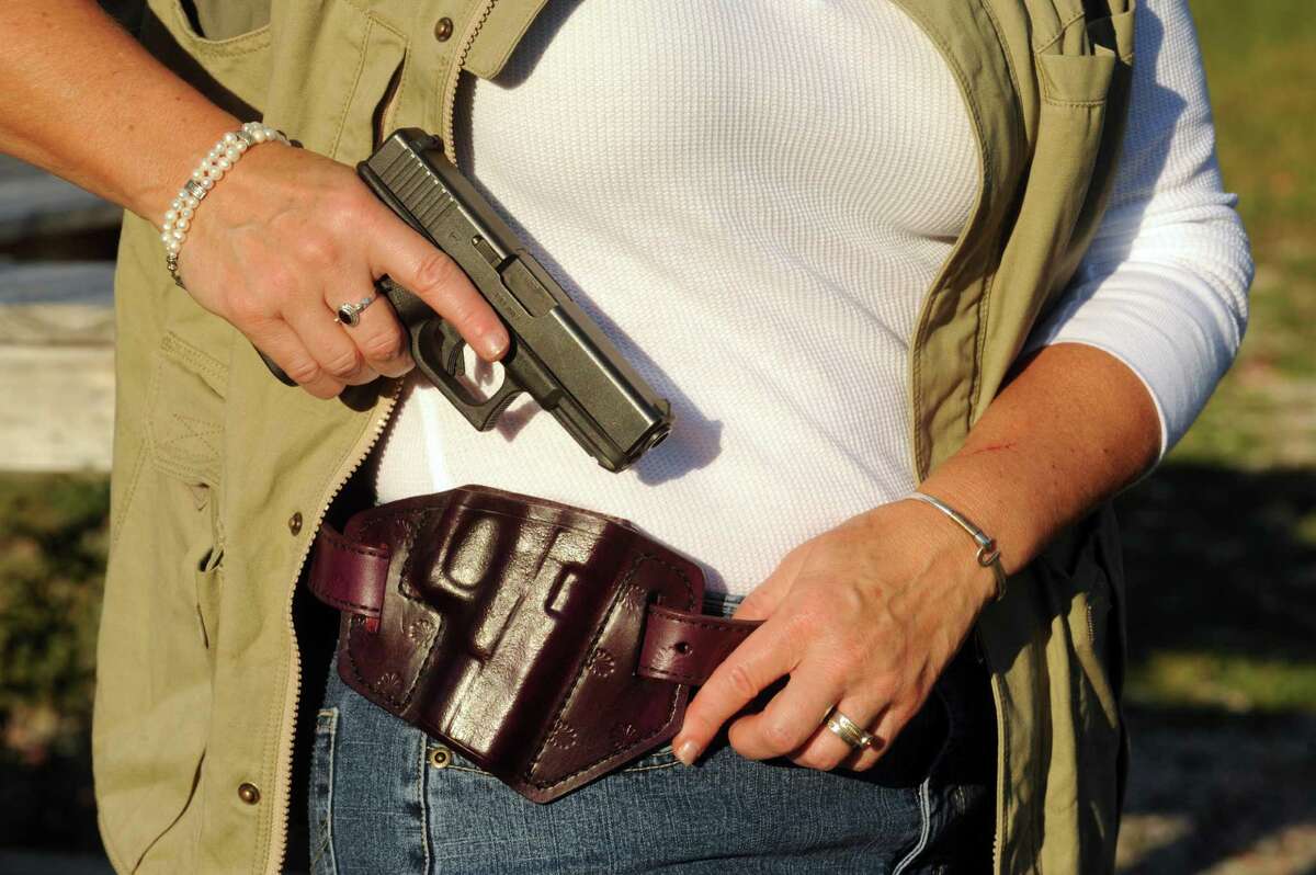 Trish Cutler wears her purple leather Glock holster and matching belt by Jesse Leather during a target practice session at the Hudson Fish and Game Club in Hudson, N.Y., Thursday Sept. 13, 2012. (Michael P. Farrell/Times Union)