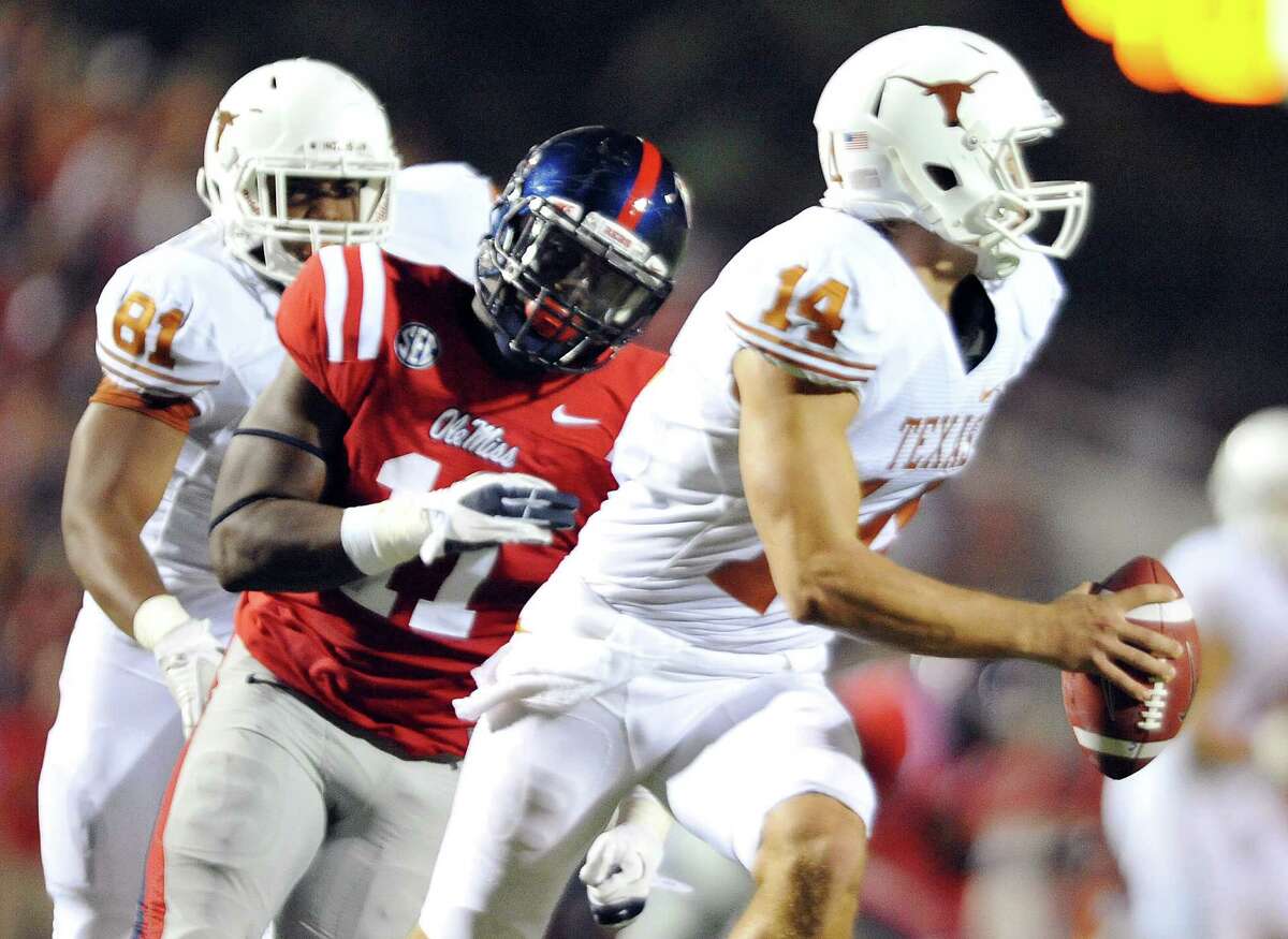 Mississippi defensive end Channing Ward (11) chases Texas' David Ash (14) during an NCAA college football game in Oxford, Miss., on Saturday, Sept. 15, 2012. (AP Photo/Oxford Eagle, Bruce Newman) MAGS OUT NO SALES MANDATORY CREDIT