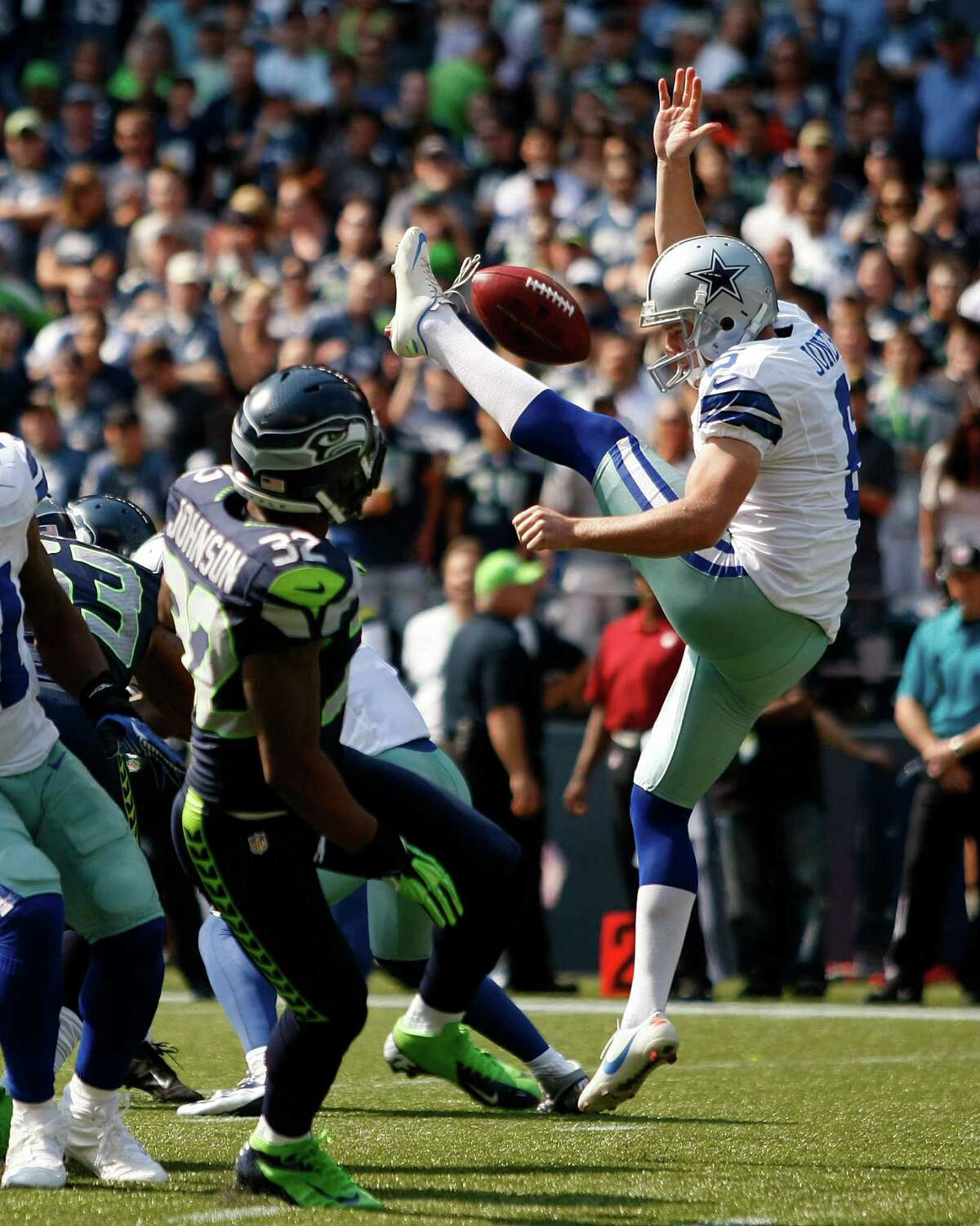 Dallas Cowboys' Chris Jones, right, has his punt blocked as Seattle Seahawks' Jeron Johnson moves in to grab it and run it in for a touchdown in the first half of an NFL football game on Sunday, Sept. 16, 2012, in Seattle. (AP Photo/John Froschauer)