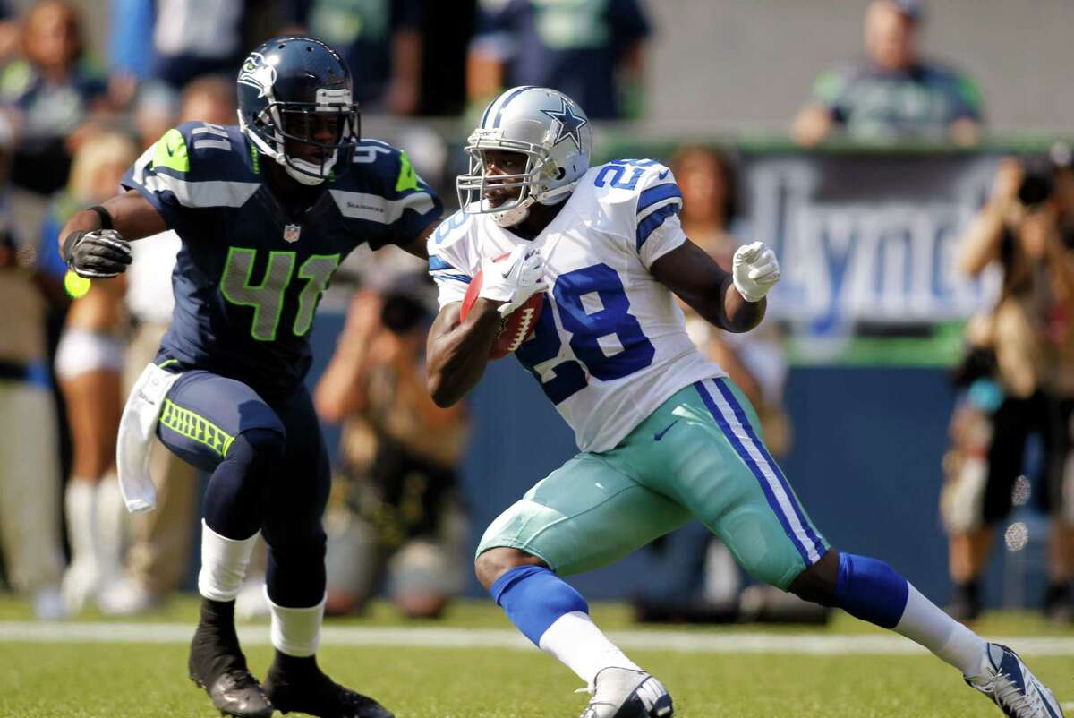 Dallas Cowboys' Felix Jones (28) rushes as Seattle Seahawks' Byron Maxwell defends in the first half of an NFL football game on Sunday, Sept. 16, 2012, in Seattle. (AP Photo/John Froschauer)