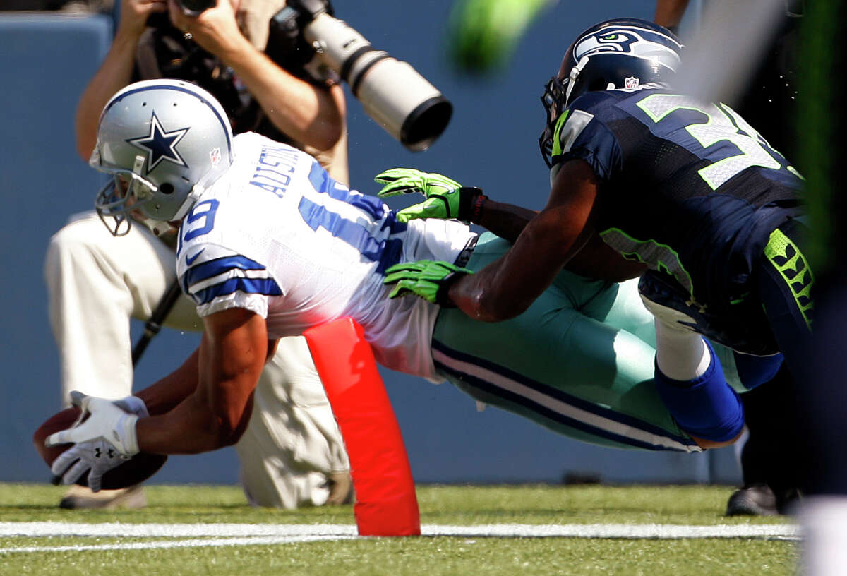Dallas Cowboys' Miles Austin, left, dives into the end zone for a touchdown as Seattle Seahawks' Brandon Browner follows in the first half of an NFL football game on Sunday, Sept. 16, 2012, in Seattle. (AP Photo/Kevin P. Casey)