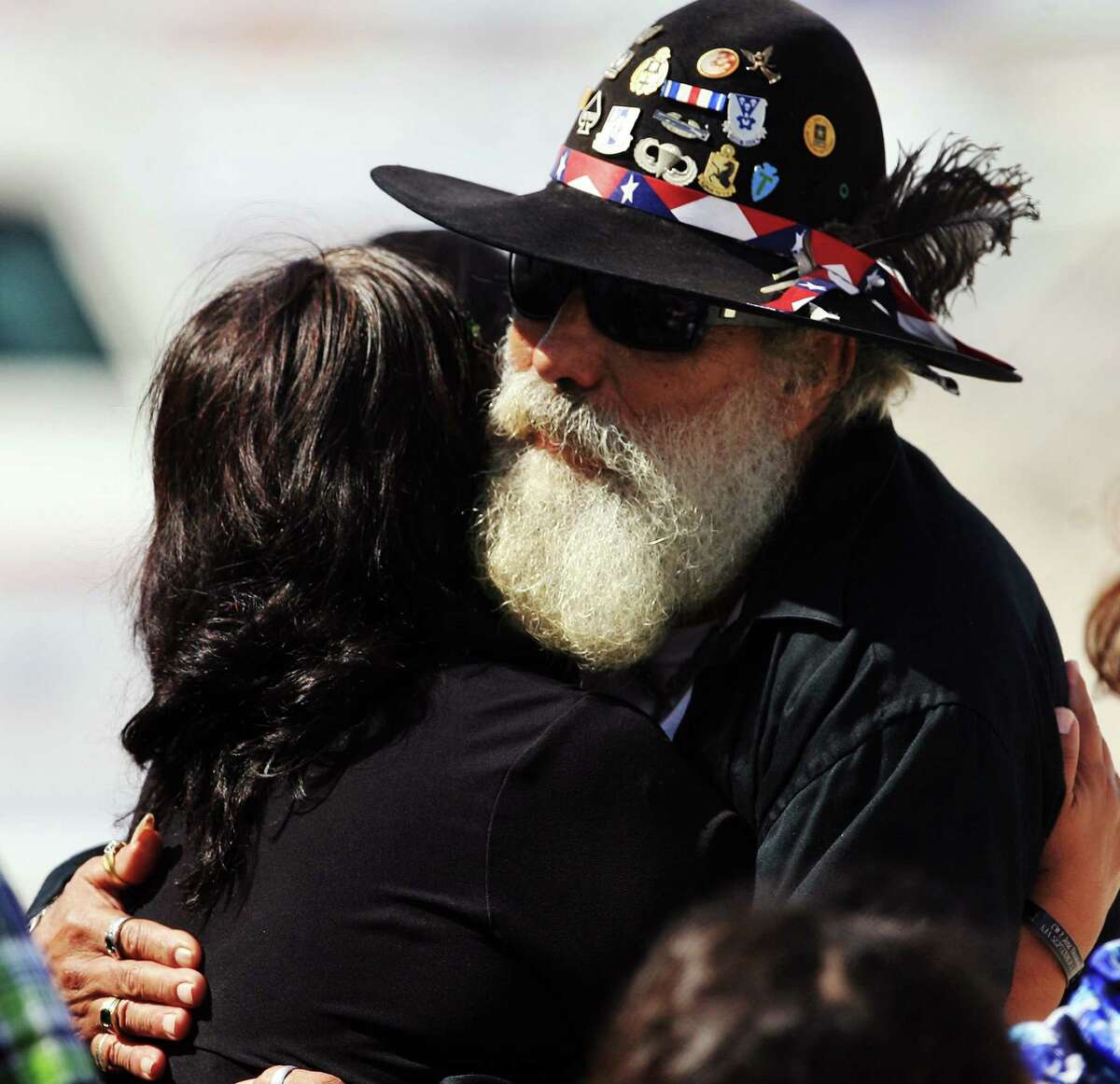 Army Veteran Macario Jose Mejia hugs Reyna Torres, mother of U.S. Army Warrant Officer Jose Luis Montenegro Jr., as they wait for the arrival of his casket Sunday, Sept. 16, 2012 at McCreery Aviation in McAllen, Texas. Montenegro was stationed at Fort Bragg, N.C., and was serving his third tour of duty overseas when his helicopter was shot down in Afghanistan's Logar province. (AP Photo/The Monitor, Gabe Hernandez)