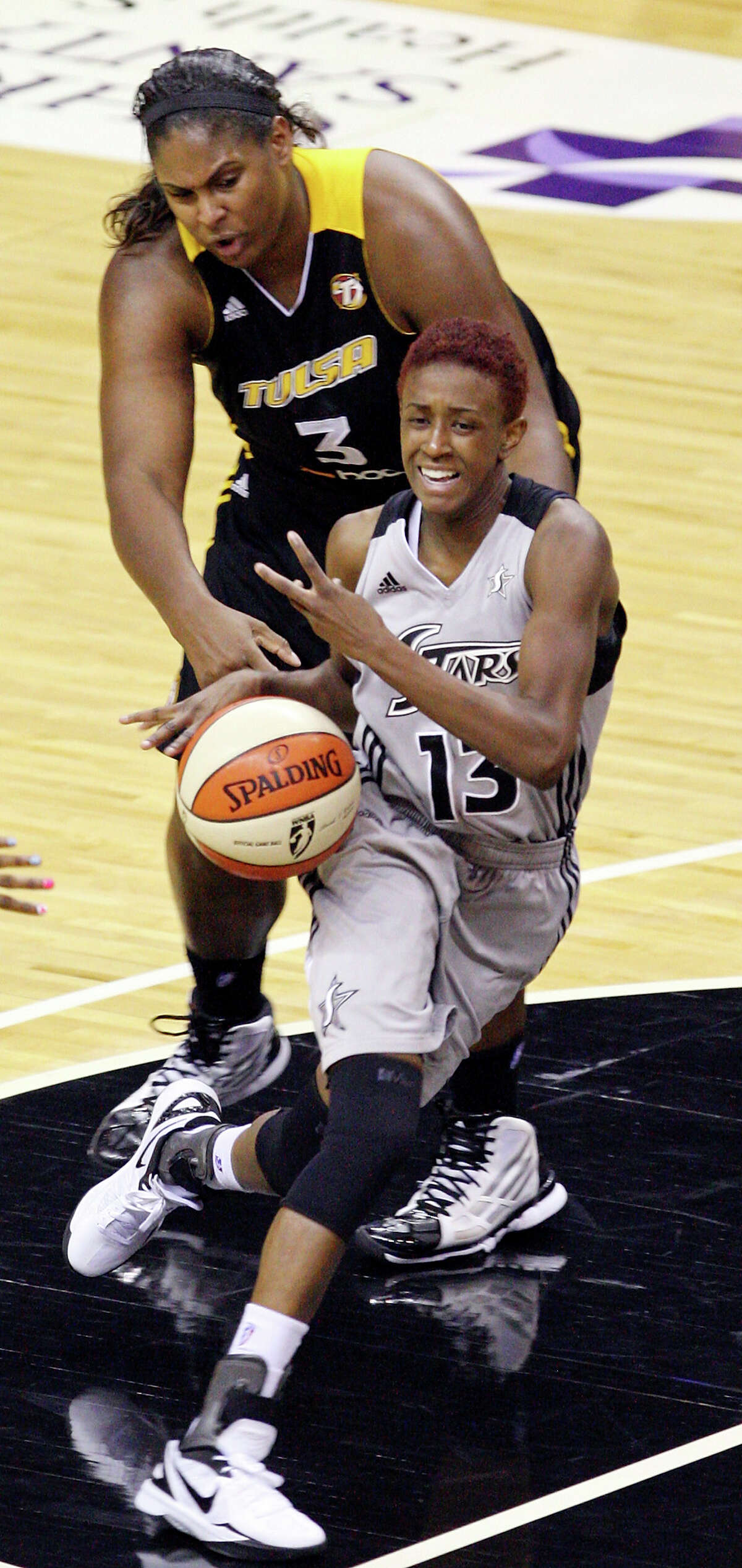 Silver Stars' Danielle Robinson looks for room around Shock's Courtney Paris during first half action Sunday Sept. 16, 2012 at the AT&T Center.