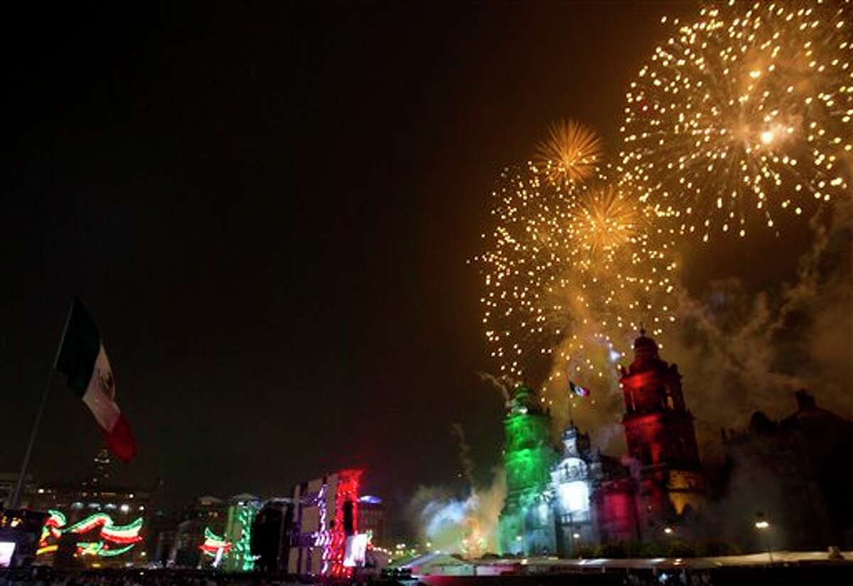 Fireworks explode over the Metropolitan Cathedral for Independence Day celebrations at the Zocalo in Mexico City, late Thursday, Sept. 15, 2011. Mexico is marking the 202nd anniversary of the "Grito de Dolores," honoring the call to arms made by the priest Miguel Hidalgo in 1810 that began the struggle for independence from Spain, achieved in 1821. (AP Photo/Eduardo Verdugo)