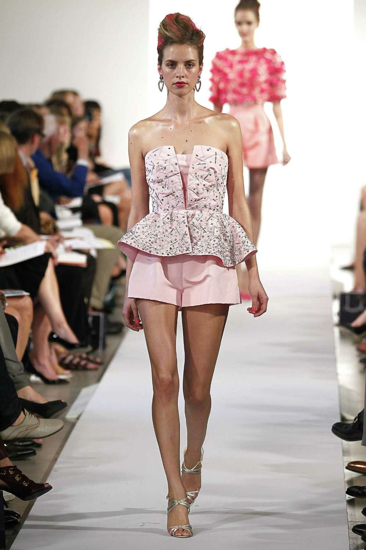 Oscar de la Renta offers flared cocktail shorts with a corset top.