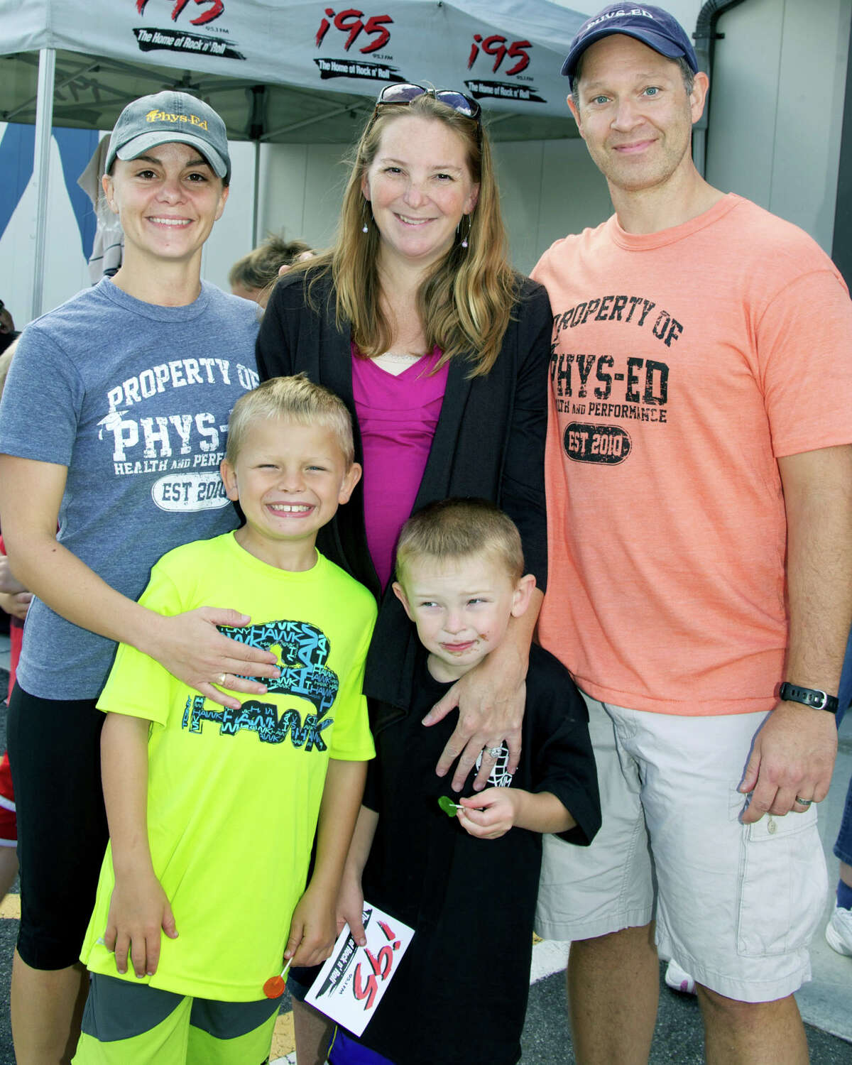 Phys-Ed's Valerie Walsh, left, and Eric Corson welcome members oi the Wilkinson family to Saturday's benefit in New Milford. Sporting smiles appreciative for the community support are Alice Wilkinson and her two sons, Jacob, left, and Everett. Sept. 15, 2012