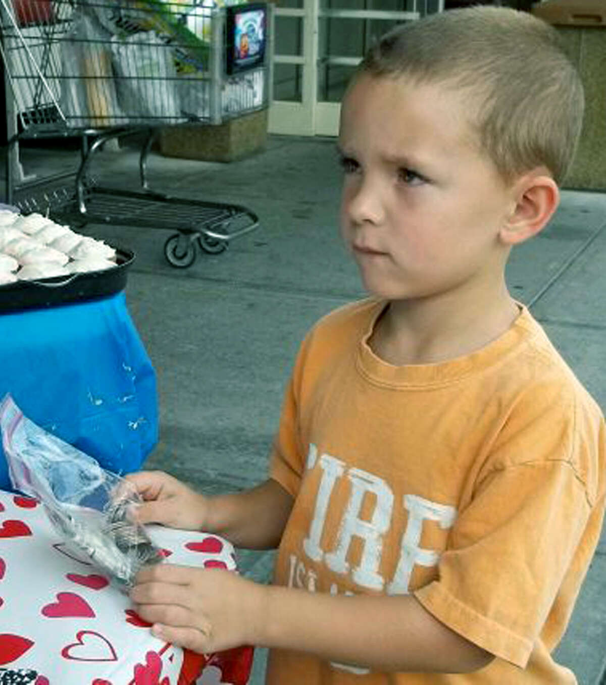Bill Kaschube, 5, of New Milford is ready to donate $24 he took from his piggy bank to the Wilkinson/Fratino bake sale fundraiser. Sept. 12, 2012