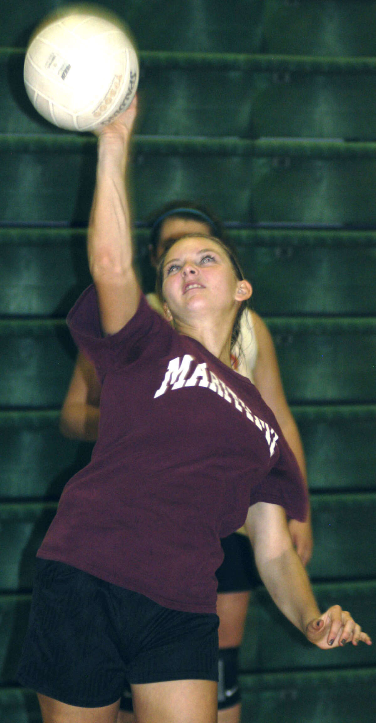 Megan Lisee grooves her serving stroke for New Milford High School volleyball, September 2012