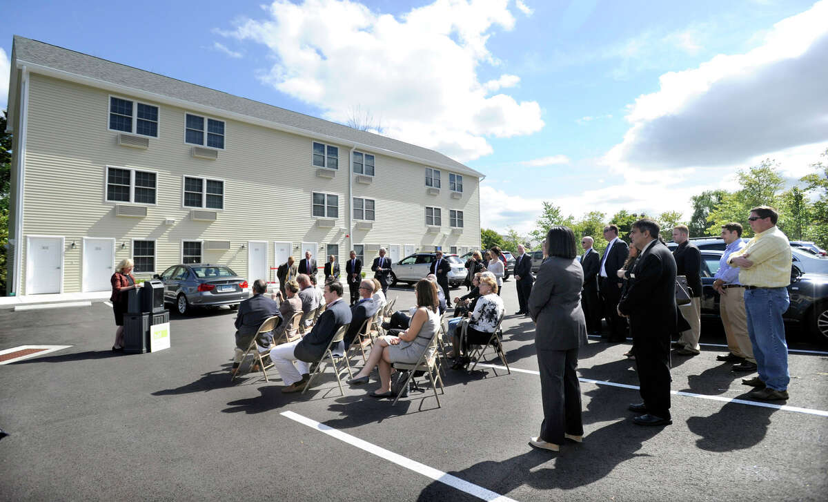 Housing Development Fund President and CEO Joan Carty addresses a gathering at the official ribbon-cutting ceremony for the 41 Grand Street housing development in Danbury, Thursday, Sept. 20, 2012.