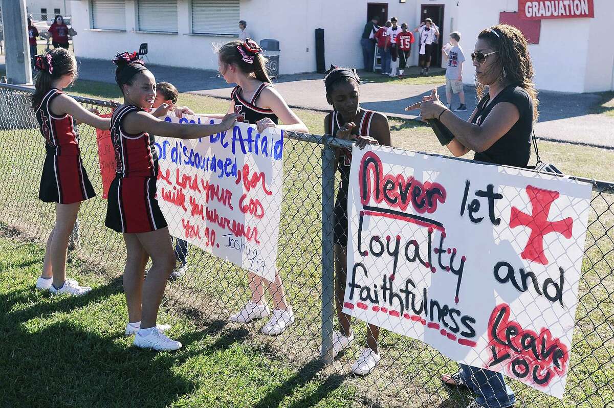 Cheerleaders used their faith-based signs at a football game held at Kountze High School on Sept. 20. PHOTO GALLERY: Mixing faith and football.