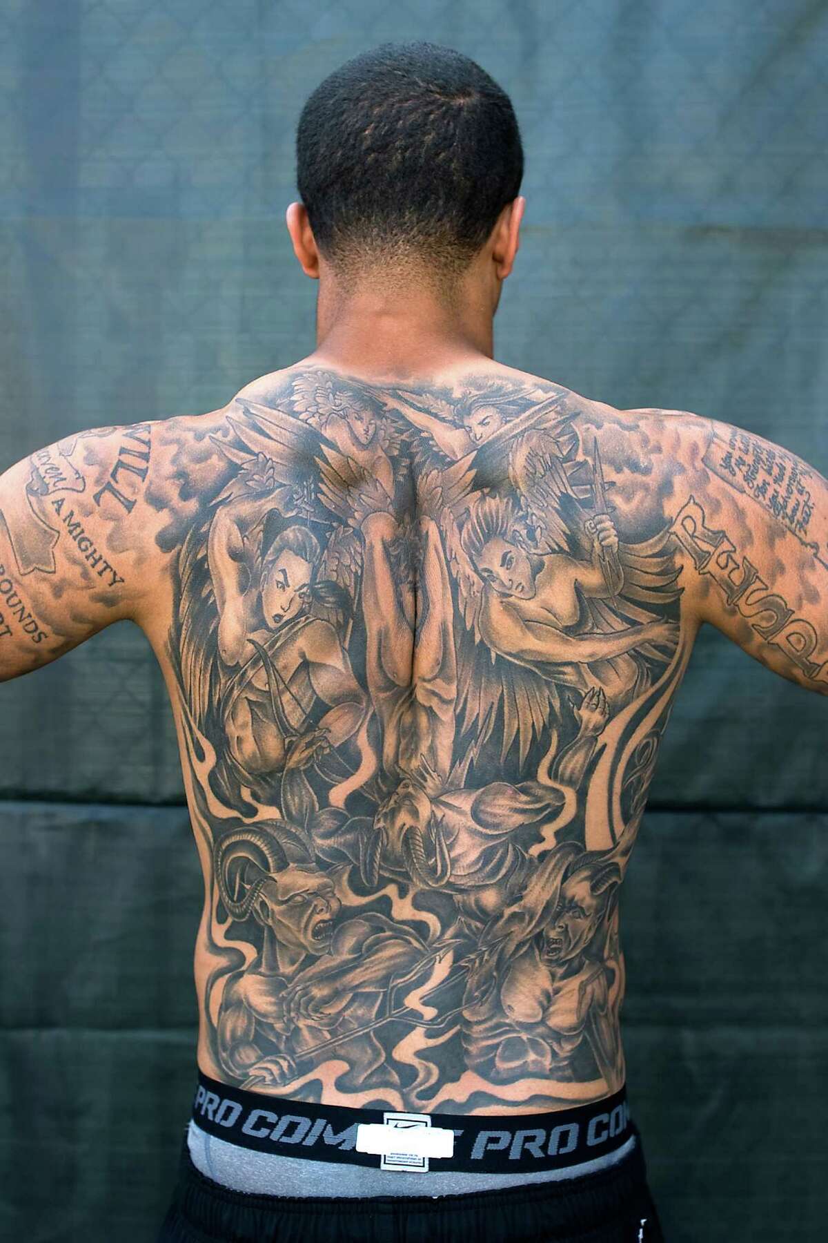Quarterback Colin Kaepernick shows off his intricate back tattoo.