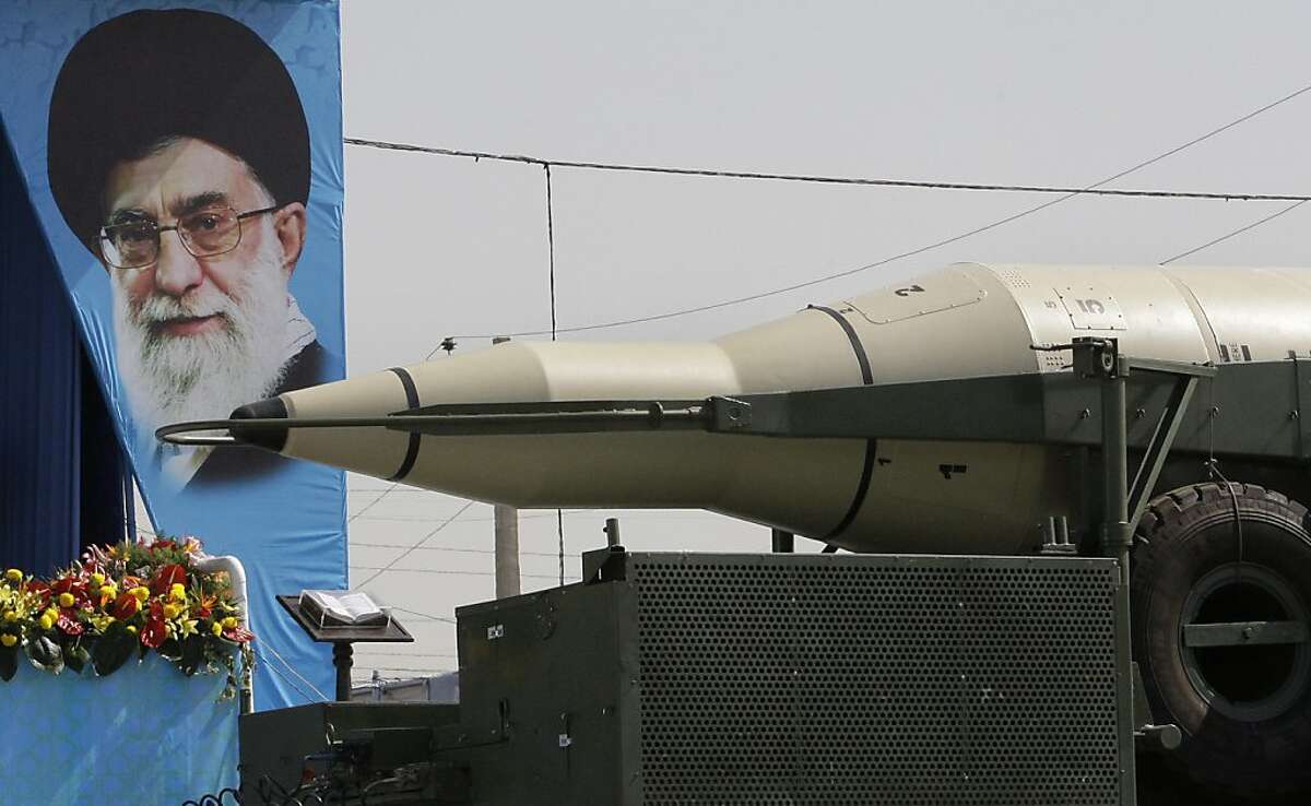 A Sajjil missile is displayed by Iran's Revolutionary Guard, in front of a portrait of the Iranian supreme leader Ayatollah Ali Khamenei, during a military parade commemorating the start of the Iraq-Iran war 32 years ago, in front of the mausoleum of the late revolutionary leader Ayatollah Khomeini, just outside Tehran, Iran, Friday, Sept. 21, 2012. (AP Photo/Vahid Salemi)