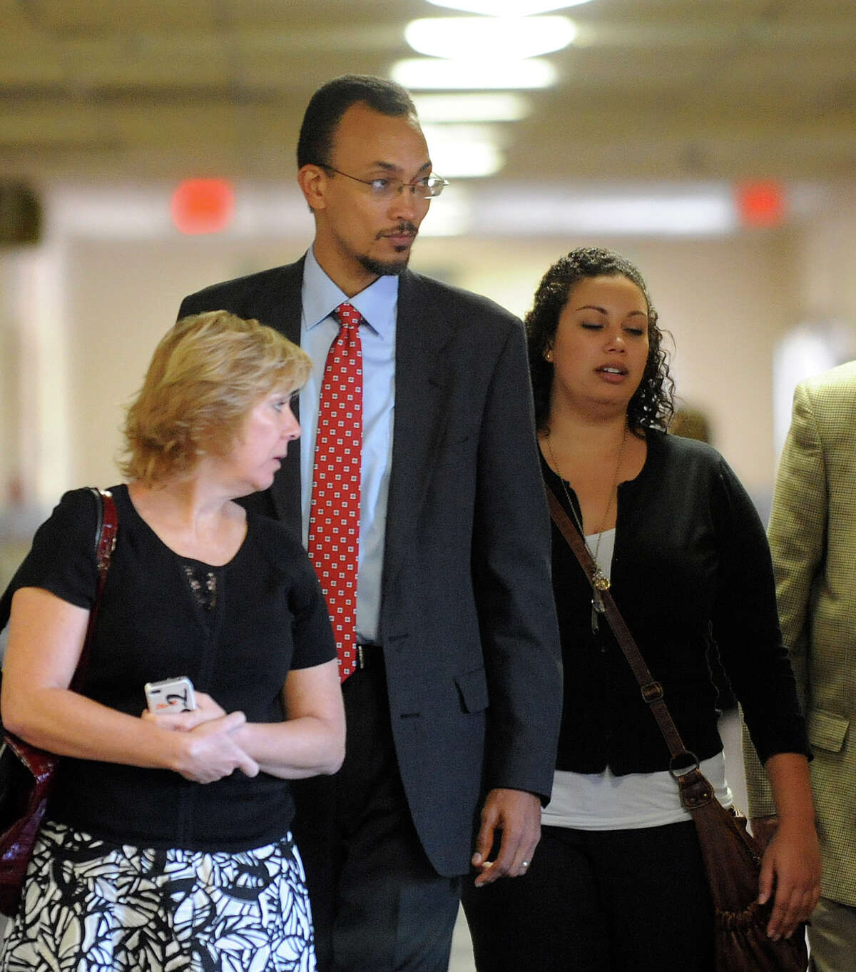 Anesthesiologist Dr. Brian Seastrunk, wearing tie, enters 37th District Court for a malpractice trial on Friday, Sept. 21, 2012. Attorneys for the parents of Maddoux Cordova, a 22-month-old boy who died after being given morphine upon Seastrunk's approval, argue that Seastrunk's decision led to the boy's death in 2009.