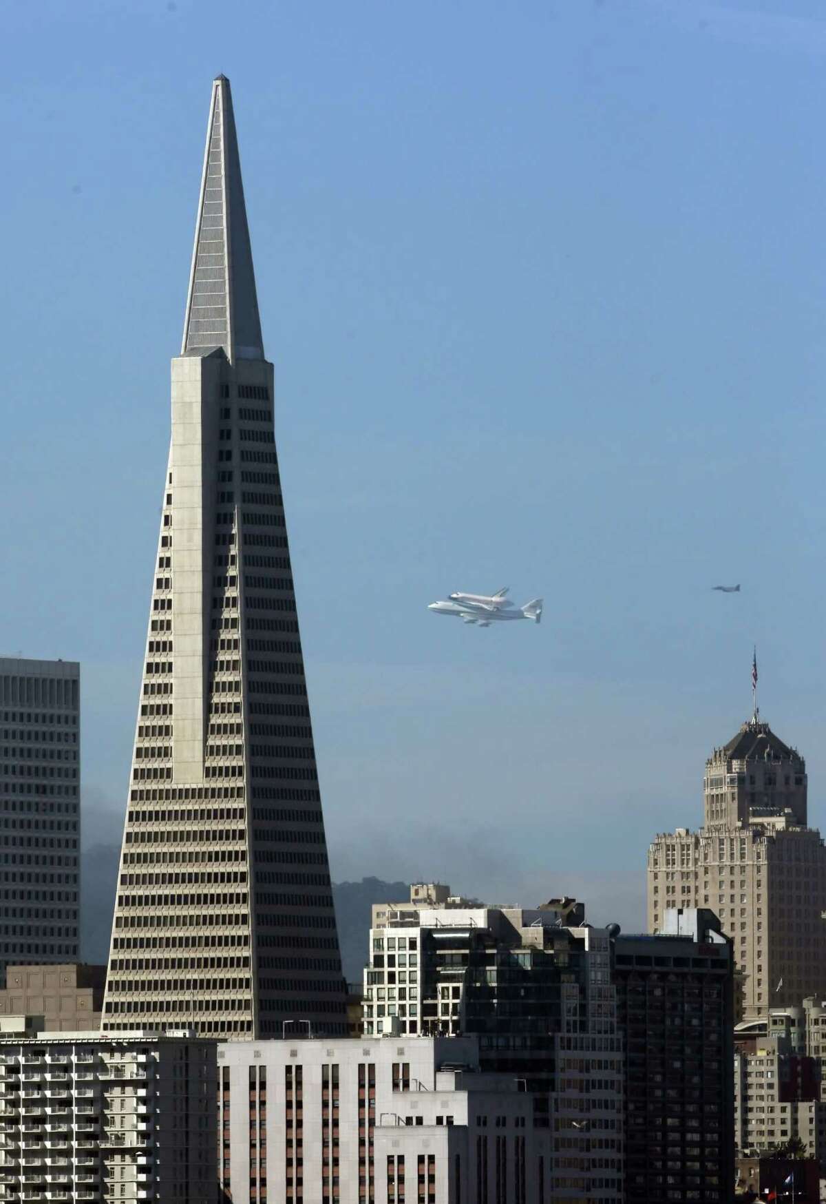 Space Shuttle Endeavour mounted on NASA's Shuttle Carrier Aircraft, flies past Transamerica Pyramid on Friday, Sept. 21, 2012, in San Francisco. Endeavour is making a final trek across the country to the California Science Center in Los Angeles, where it will be permanently displayed.