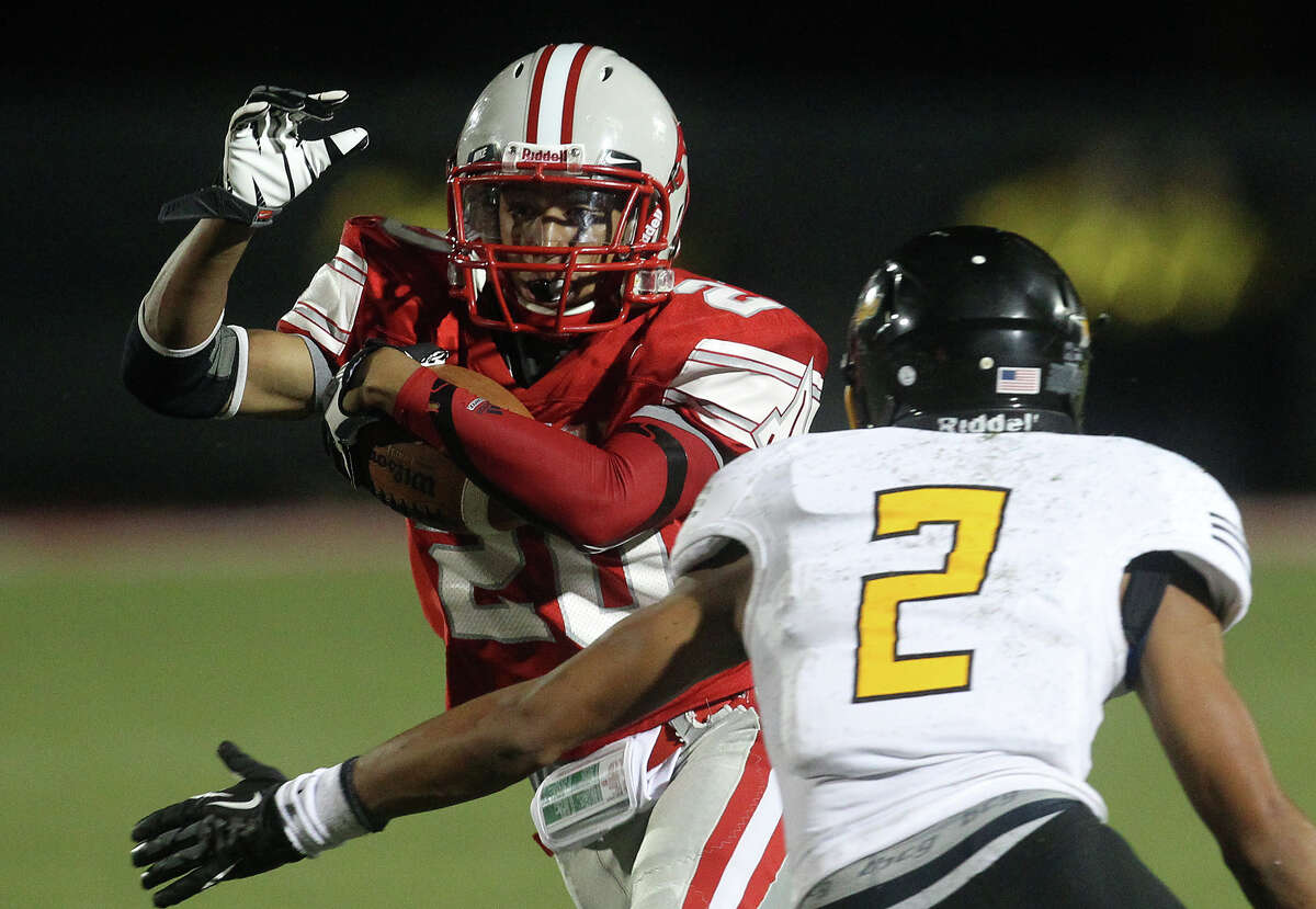 Judson's Brandon Sanders (20) attempts to run around East Central's Austin Jupe (02) during their game at D.W. Rutledge Stadium on Friday, Sept. 21, 2012.