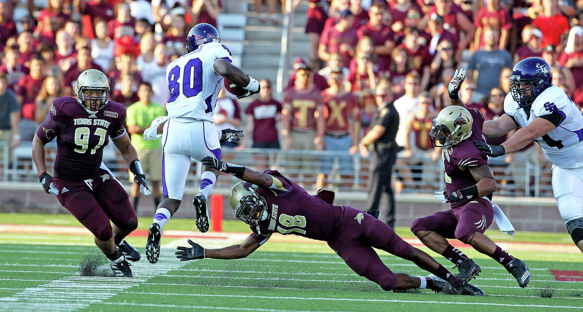 Bobcat defenders try to stop Cordell Roberson as Texas State hosts Stephen F. Austin at Bobcat Stadium on September 22, 2012.