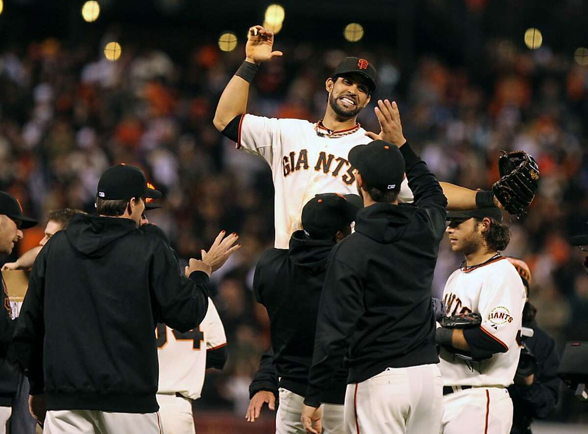 Angel Pagan is lifted by his teammates as San Francisco Giants celebrate their 8-4 win over the San Diego Padres that gave them the National League West title Saturday September 22, 2012. In San Francisco California.
