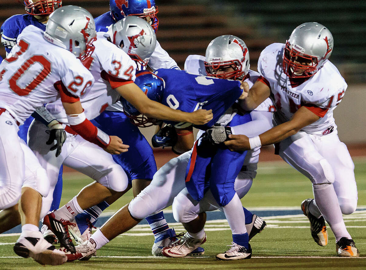 Jefferson running back Joseph Luna is stopped by Lee's Sam Adams (from left), Nick Allie, Alex Lugo and James Hernandez during their game at Alamo Stadium on Sept. 21, 2012. MARVIN PFEIFFER/ mpfeiffer@express-news.net