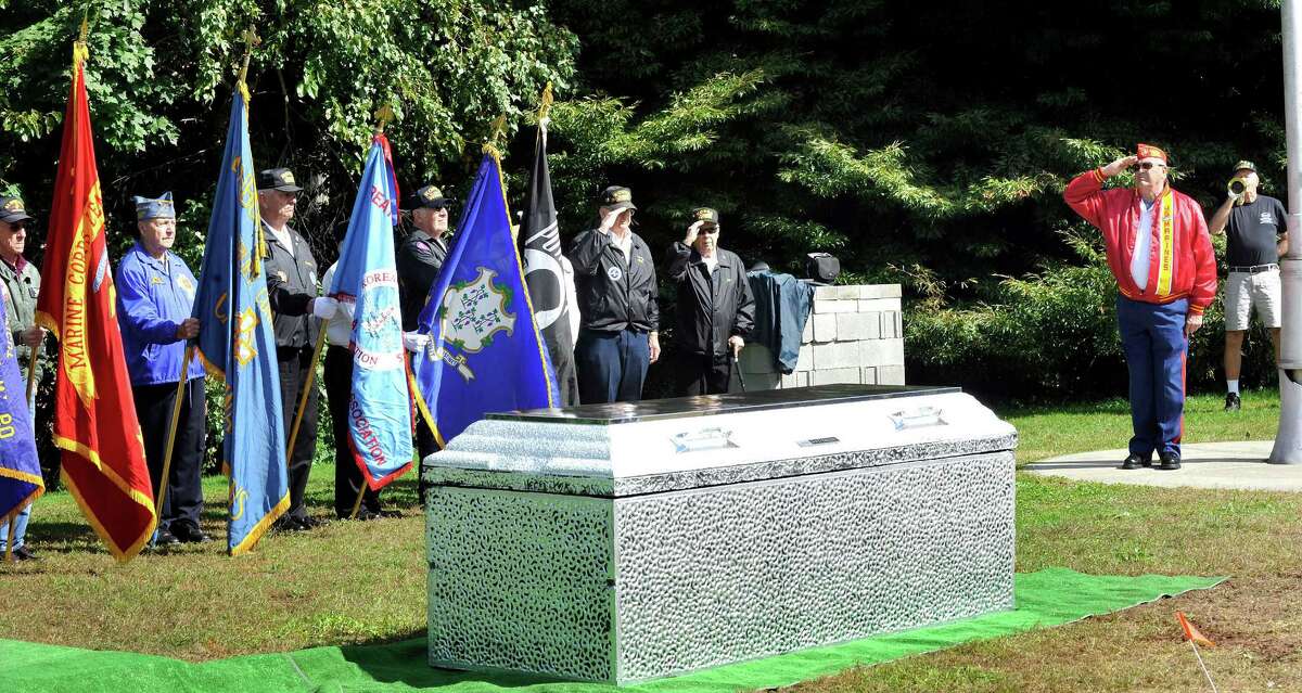 The color guard stands at attention while Taps is played behind a vault containing memorabilia during a closing ceremony for the Dignity Memorial Vietnam Wall in Danbury Monday, Sept. 24, 2012.