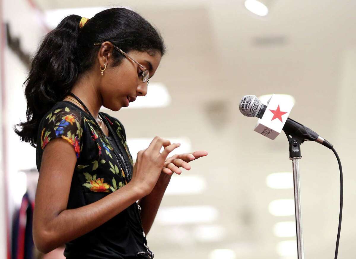 Shobha Dasari, 11, of Pearland uses her hands to spell the word "flammable" correctly in the fourth round of the Macy's Spelling Bee. She went on to win the competition.