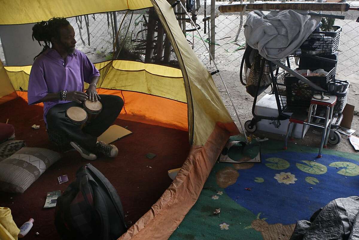 Rashan Hylton drumming in his tent at a homeless encampment under highway 280 on King at Fifth streets in San Francisco, Calif., on Monday, September 24, 2012. A past vocalist and musician, he has been living in the encampment for two years.