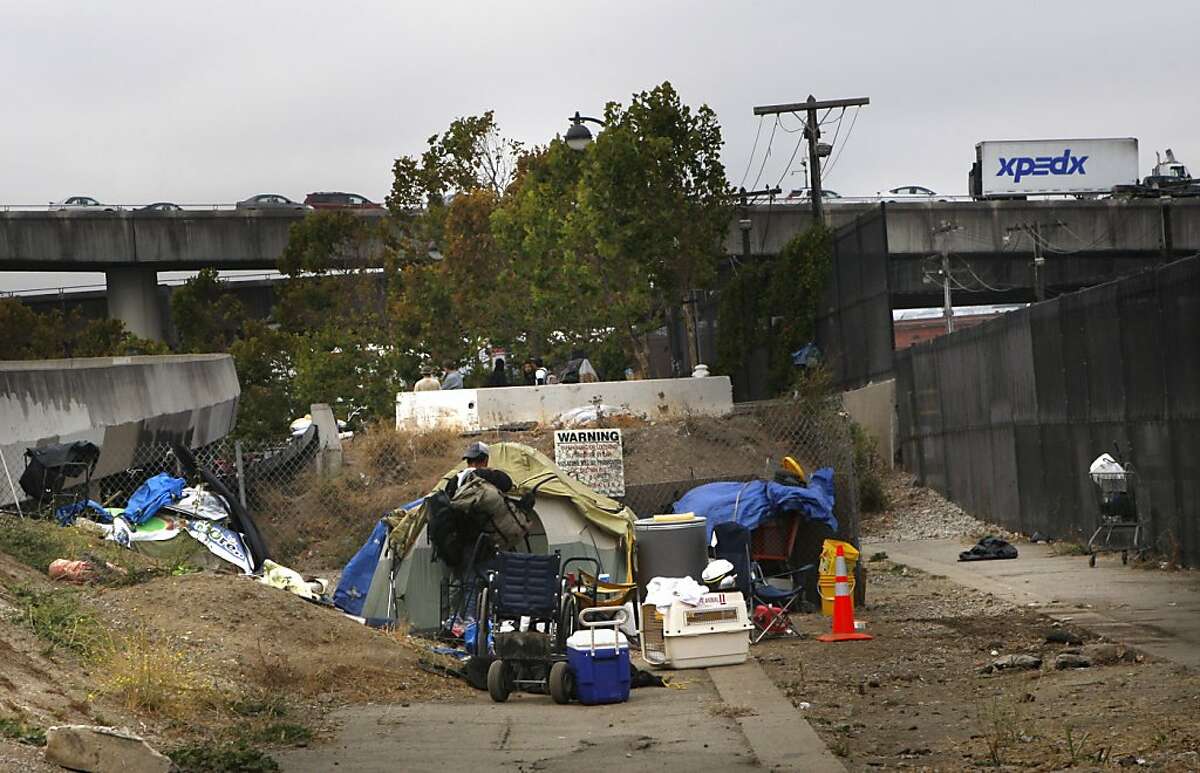 A man moving some of his belongings at a homeless encampment under highway 280 on King at Fifth streets in San Francisco, Calif., on Monday, September 24, 2012.