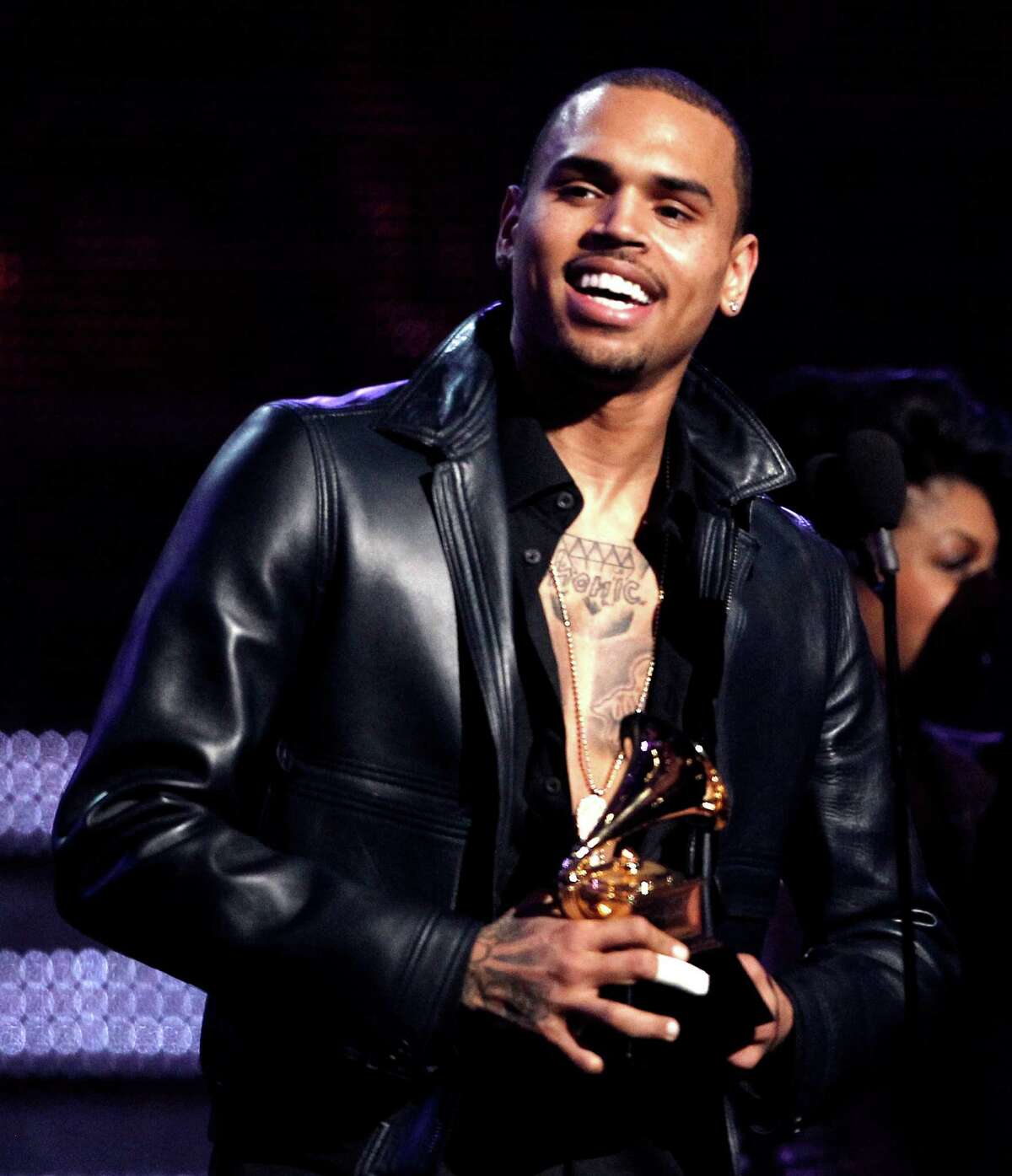 FILE - In this Feb. 12, 2012 file photo, Chris Brown accepts the award for best R&B album for "F.A.M.E." during the 54th annual Grammy Awards in Los Angeles. A judge in Los Angeles ordered a further review of Brown's community service on Monday, Sept. 24, 2012 and set another hearing to determine whether the singer is in compliance with the terms of his probation for the 2009 beating of then-girlfriend Rihanna. (AP Photo/Matt Sayles, File)
