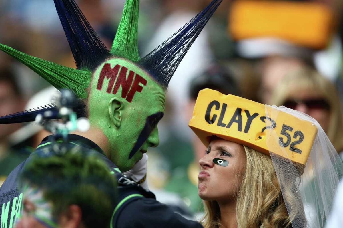 Seattle Seahawks fan Mr. Mohawk faces off with a Green Bay Packers fan during Monday Night Football on September 24, 2012 at CenturyLink Field in Seattle.