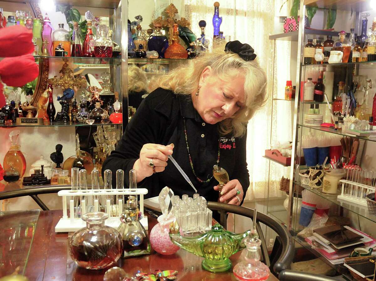 Old Town Spring business owner Diana Bill-Jordan adds pheromones to one of her custom-made perfumes at her Crazy Mama's shop. Bill-Jordan makes her custom perfumes to match each customers' personality and smell.