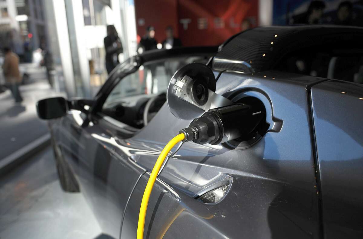This file image shows an electric cable plugged into a Tesla Roadster Sport February 10, 2011 during the launch of the new Tesla showroom in Washington, DC.