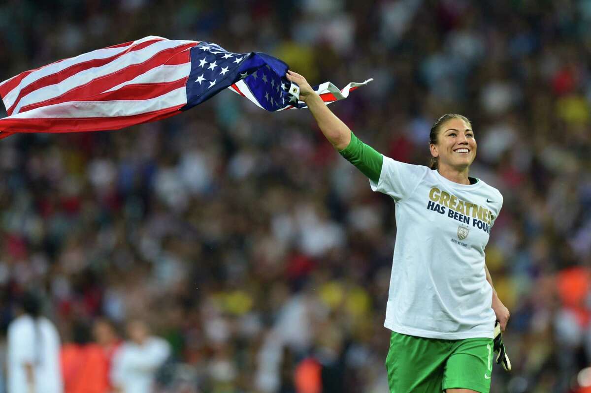 United States's goalkeeper Hope Solo celebrates with the U.S. flag after the final of the women's soccerl competition of the London 2012 Olympic Games versus Japan on Aug. 9, 2012, at Wembley stadium in London. The US team defeated Japan 2-1 to win the gold medal.