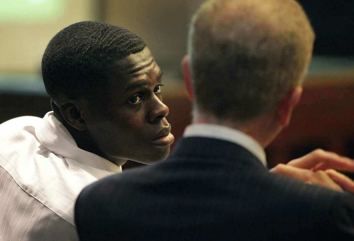 Kwaku Agyin, left, confers with his attorney Mario Trevino during his child sex trafficking trial in Judge Lori Valenzuela's 437th state District Court. Wednesday, Sept. 26, 2012.