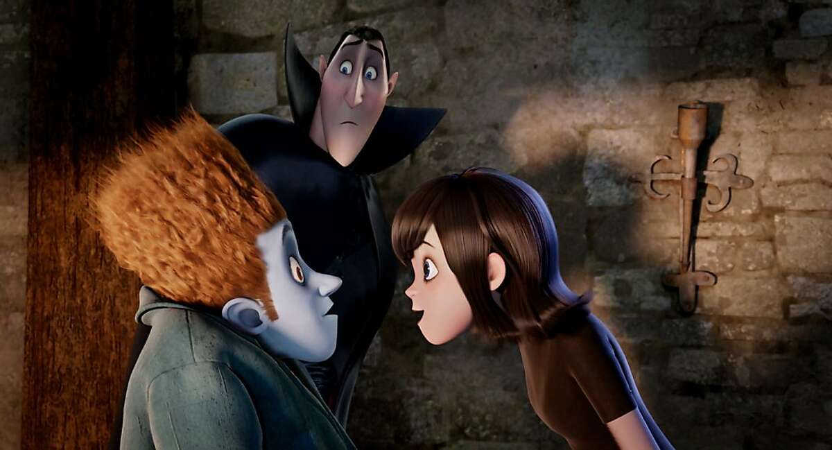 Johnnystein (Andy Samberg) and Mavis (Selena Gomez) with Dracula (Adam Sandler) looking on in HOTEL TRANSYLVANIA, an animated comedy from Sony Pictures Animation.