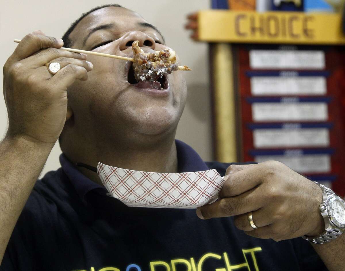 Texas State Representative Eric Johnson, one the three judges that judged the eight-finalist in the cook-off for the Big Tex Choice awards, leans back as he taste the Fried Bacon Cinnamon Roll, created by Butch Benavides, Monday, September 3, 2012 at the State Fair of Texas. Benavides who won Most Creative. (David Woo/The Dallas Morning News)