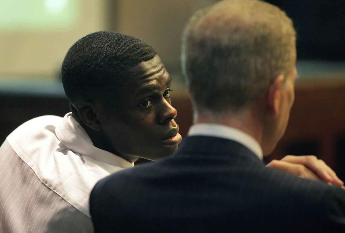 Kwaku Agyin, left, confers with his attorney Mario Trevino during his child sex trafficking trial in Judge Lori Valenzuela's 437th state District Court. Wednesday, Sept. 26, 2012.