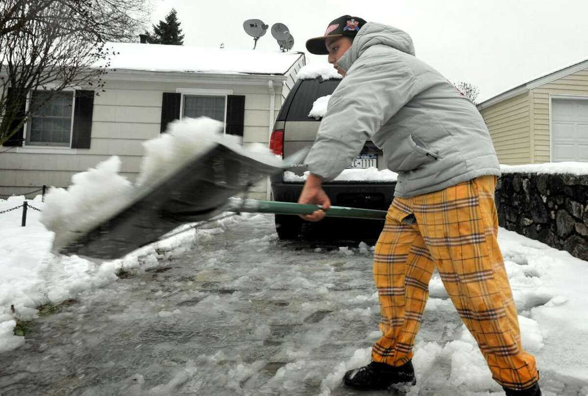 Christian Villo, 15, shovels wet snow from the driveway of his Danbury home on Wendesday, Dec.9, 2009.