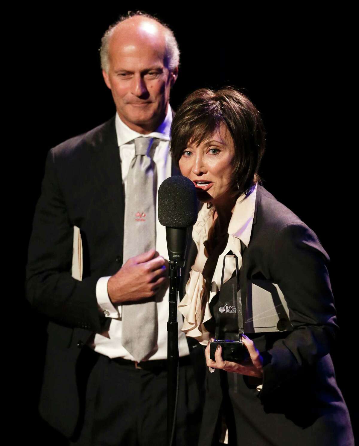 Country music star Pam Tillis and Italian bluegrass musician Martino Coppo, left, accept the guitar player of the year award on behalf of the late Doc Watson at the International Bluegrass Music Association Awards show on Thursday, Sept. 27, 2012, in Nashville, Tenn. (AP Photo/Mark Humphrey)