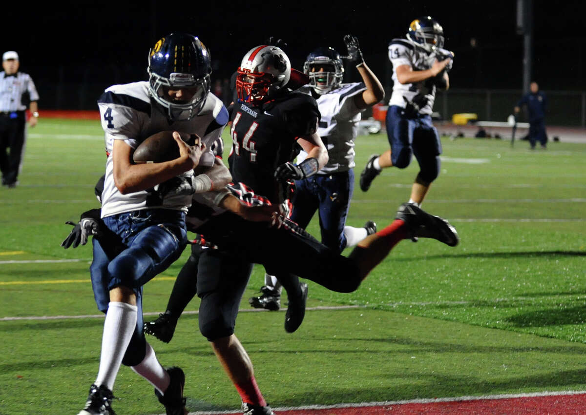 Weston's #4 Erik Dammen-Brower crosses into the endzone for a touchdown, during football action against Pomperaug in Southbury, Conn. on Friday September 28, 2012.