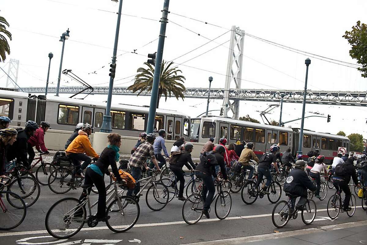 Bicyclists ride along the Embarcadero during the 20th anniversary Critical Mass ride through downtown in San Francisco, Calif., Friday, September 28, 2012.