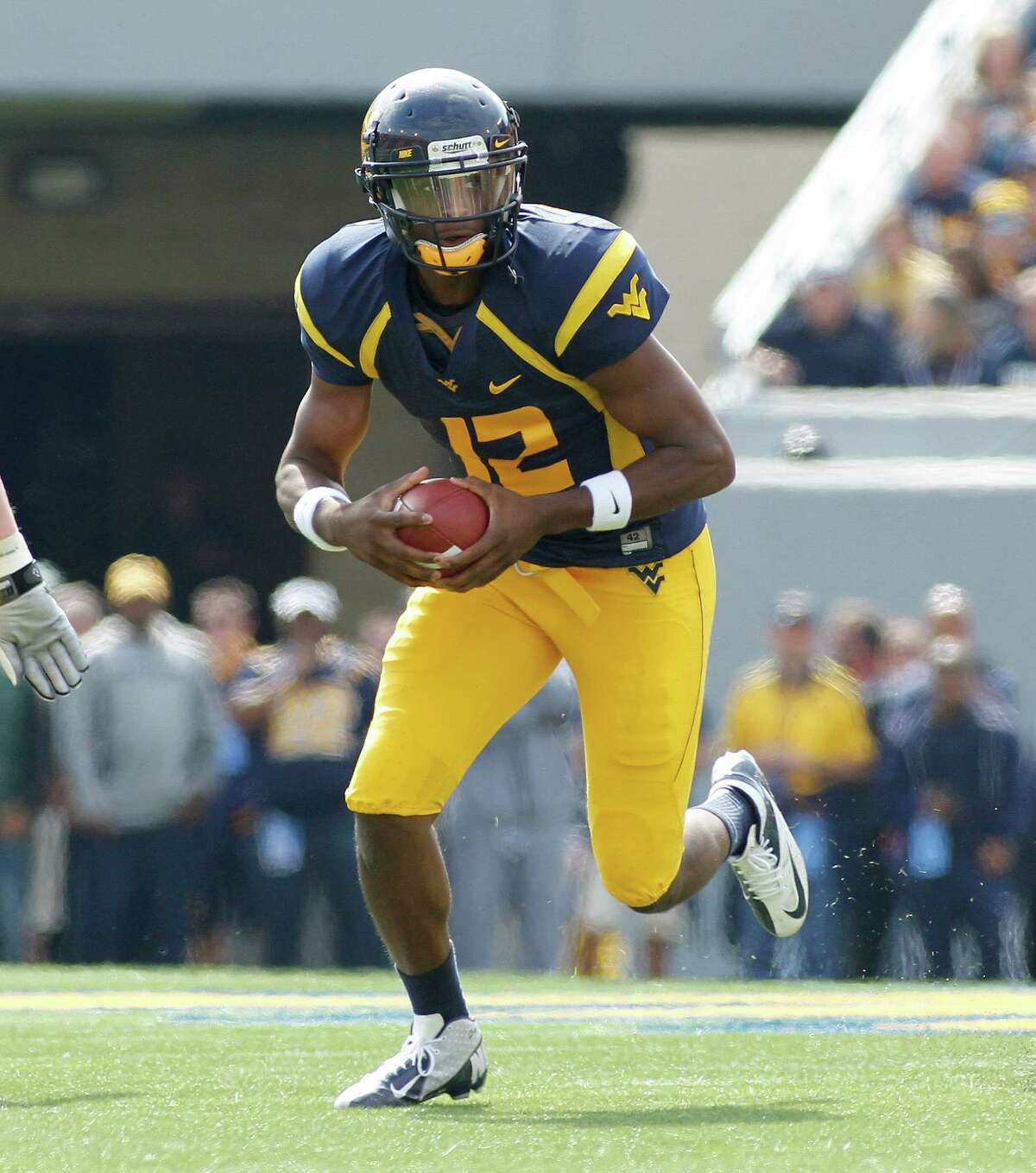 MORGANTOWN, WV - SEPTEMBER 29: Geno Smith #12 of the West Virginia Mountaineers runs the ball against the Baylor Bears during the game on September 29, 2012 at Mountaineer Field in Morgantown, West Virginia.