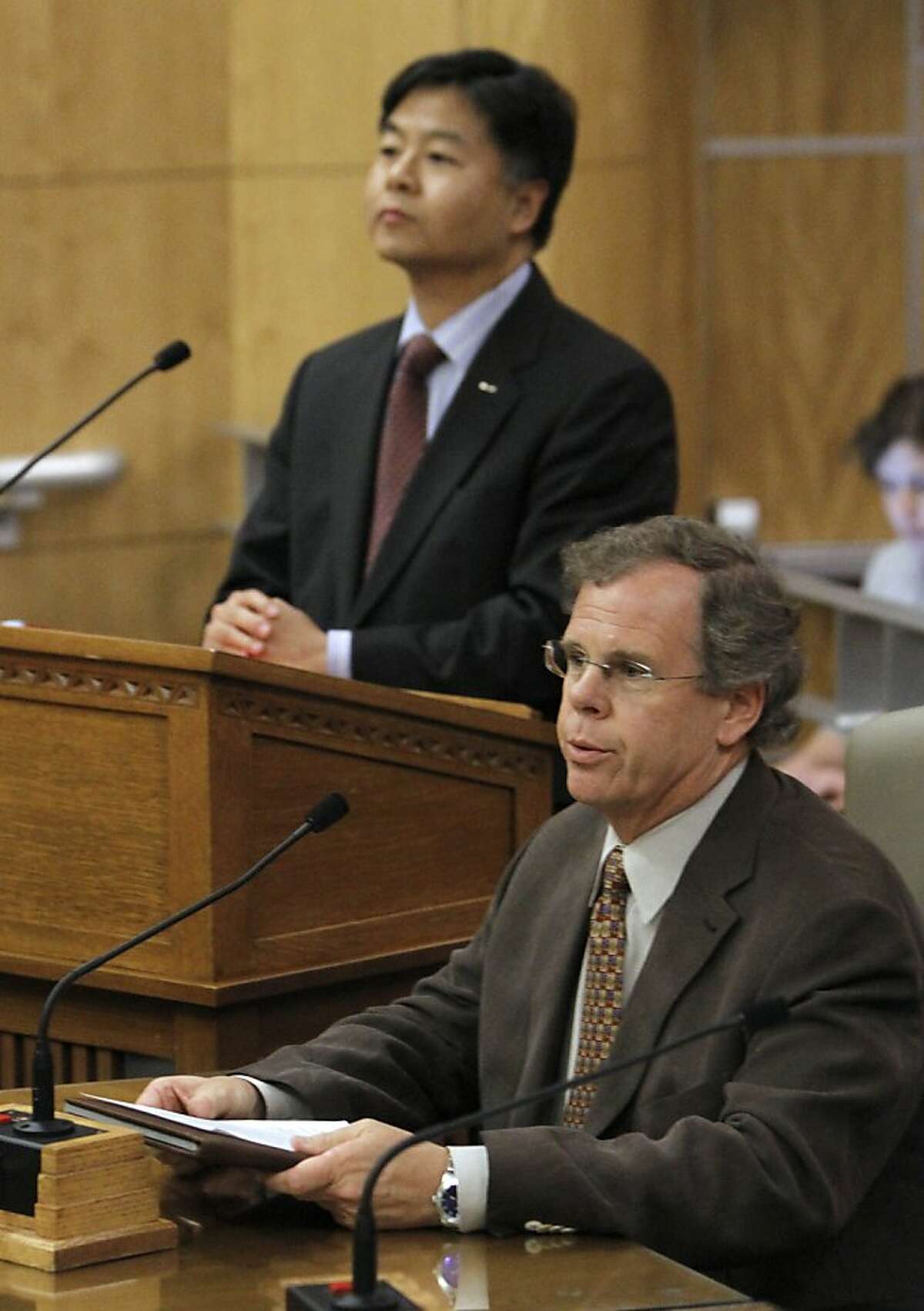 Attorney Peter Drake, executive director of the Coming Out Into Light Foundation, right, speaks about his negative experiences while receiving a controversial form of psychotherapy aimed at making gay people straight, while testifying in favor of a bill to ban the therapy during a hearing at the Capitol in Sacramento, Calif., Tuesday, May 8, 2012. The bill, SB1172, by state Sen.Ted Lieu, D-Torrence, left, would prohibit so-called reparative therapy for minors and obligate adults to sign a release form stating that the counseling is ineffective and possibly dangerous. It was passed by the Senate Judiciary Committee 3-1. (AP Photo/Rich Pedroncelli)