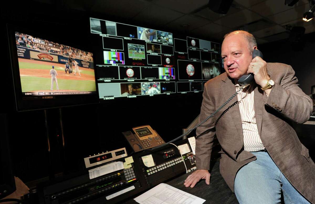 Greenwich resident John Filipelli, program director at YES Network, speaks on the phone while in the television control room of the network in Stamford,Tuesday, Aug. 14, 2012.