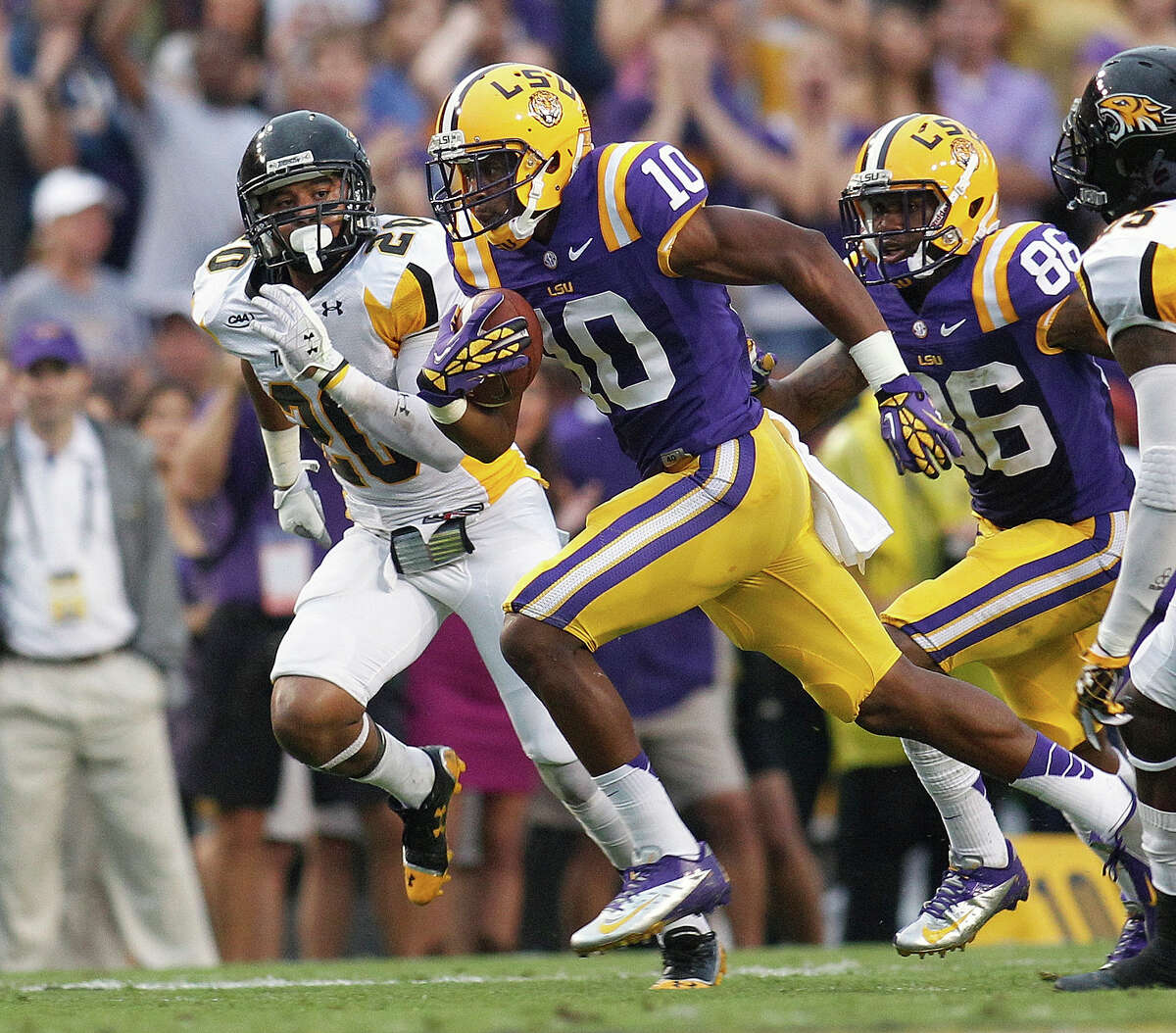 LSU wide receiver Russell Shepard (10) runs on a 78-yard touchdown in the first half of an NCAA college football game against Towson in Baton Rouge, La., Saturday, Sept. 29, 2012. Behind him are Towson safety Jordan Dangerfield (20) and LSU wide receiver Kadron Boone (86). (AP Photo/Bill Haber)
