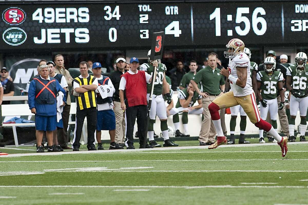 San Francisco 49ERS Colin Kaepernick breaks a tackle from New York