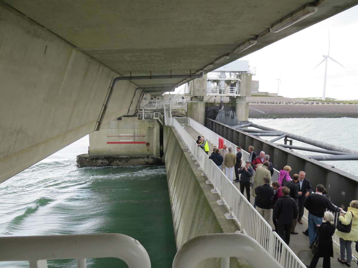 On the catwalk of the Scheldt Storm Surge Barrier in the Netherlands, which protects the Dutch coastline, are members of a Galveston fact-finding delegation.