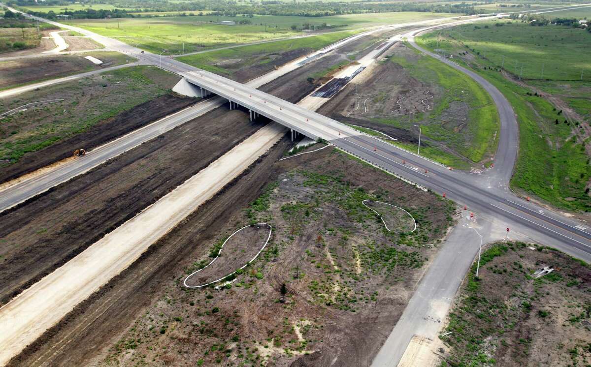 A smaller road crosses over the still-under-construction Texas 130 between Lockhart and Seguin this summer. An extension from south Austin to Seguin is the state's first public-private toll road to open to traffic.