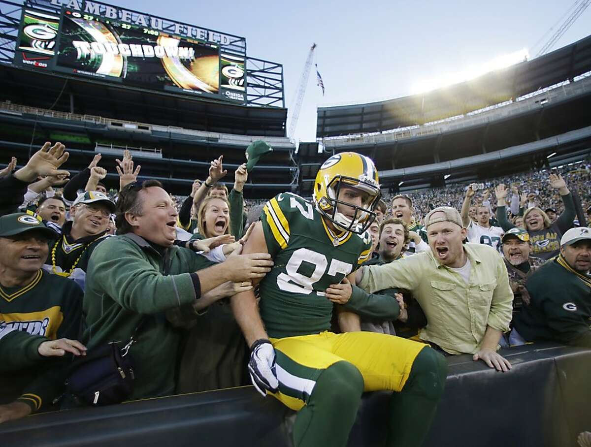 Green Bay Packers' Jordy Nelson is congratulated by fans in the stands after his touchdown catch against the New Orleans Saints during the fourth quarter of an NFL football game Sunday, Sept. 30, 2012 in Green Bay, Wis. The Packers won 28-27. (AP Photo/Jeffrey Phelps)