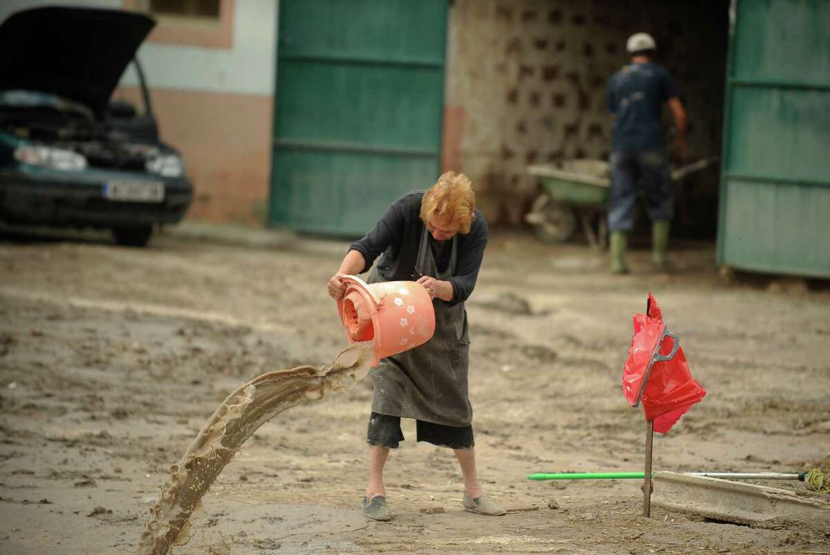 Beatriz, a resident of the southern city of Lorca, cleans a flooded street of Lorca, near Murcia, southeastern Spain, on September 30, 2012. Ten people in total have died in Spain in the regions of Andalusia and Murcia due to flash flooding brought on by downpours. The heavy rains have also damaged homes, caused the collapse of two bridges and forced roads to close. AFP PHOTO/Pedro ARMESTREPEDRO ARMESTRE/AFP/GettyImages