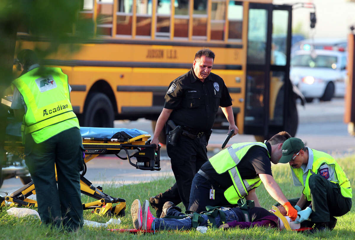 Police and paramedics prepare to transport a student after a San Antonio Independent School bus and a Judson Independent School District School bus collided on Foster road in front of Karen Wagner High School about 7:30 a.m. Monday October 1, 2012. The 60-year-old female bus driver of the SAISD bus died at the scene and three students were transported to area hospitals with minor injuries according to Bexar County Sheriff's Office Lt. Jose Trevino.
